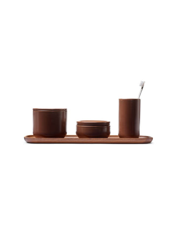 Vincent Van Duysen mocca brown ceramic bathroom set with large and small stoneware containers, toothbrush goblet, and matching tray.