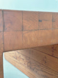 Close-up of corner joinery on solid wood stool with artisan finish