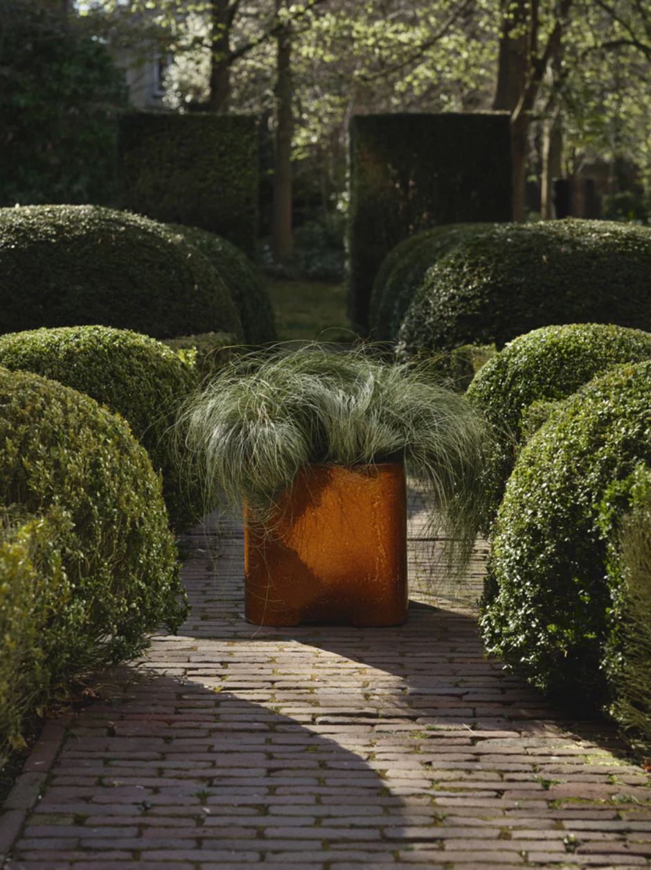 Modern ceramic indoor planter with sculptural cube shape and warm finis