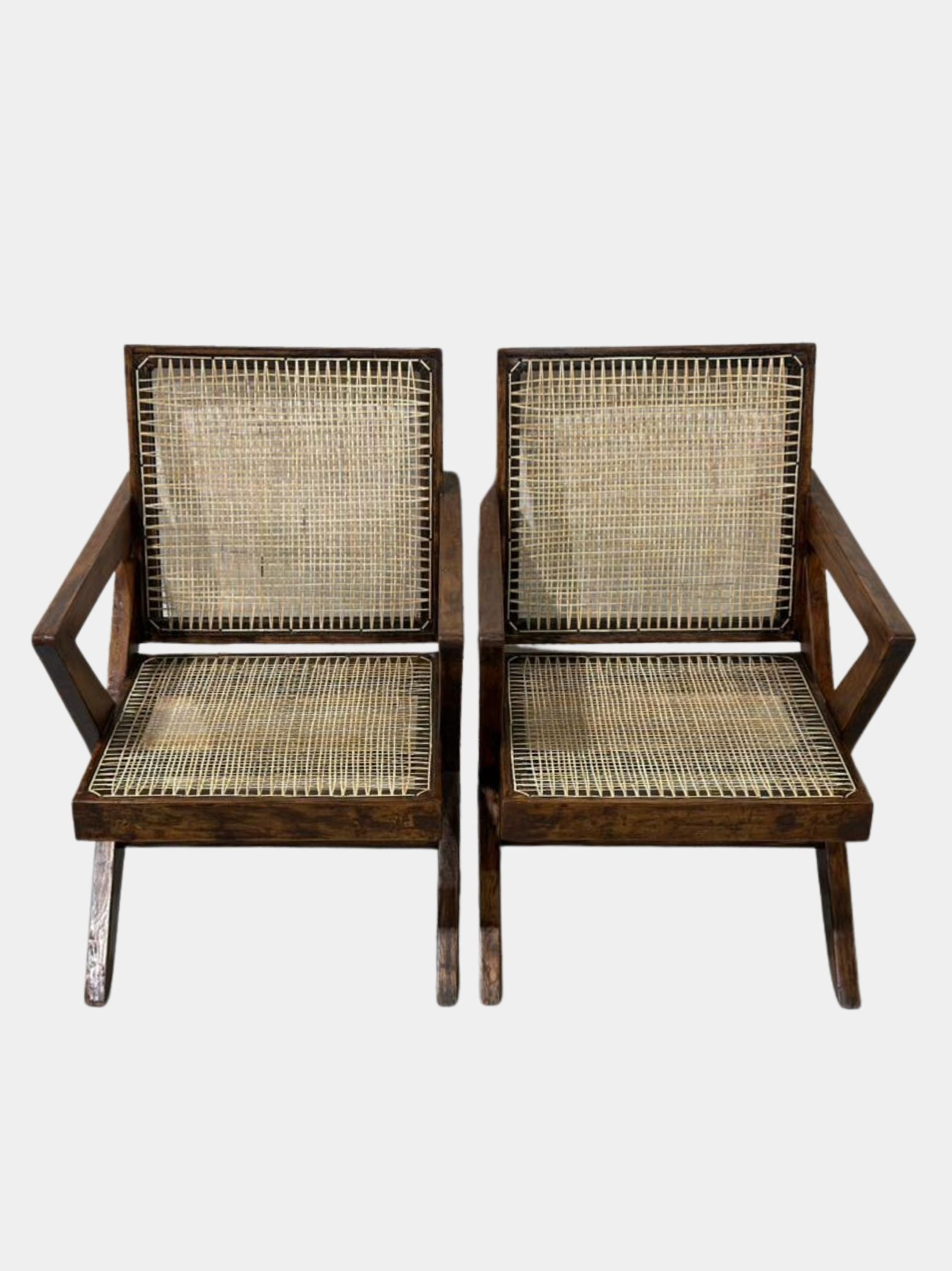 Front angle of two Pierre Jeanneret cross-leg lounge chairs, authentic mid-century modern design from Chandigarh, H.C.S. marked