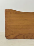 Wooden stool front view with a vintage finish on a light background