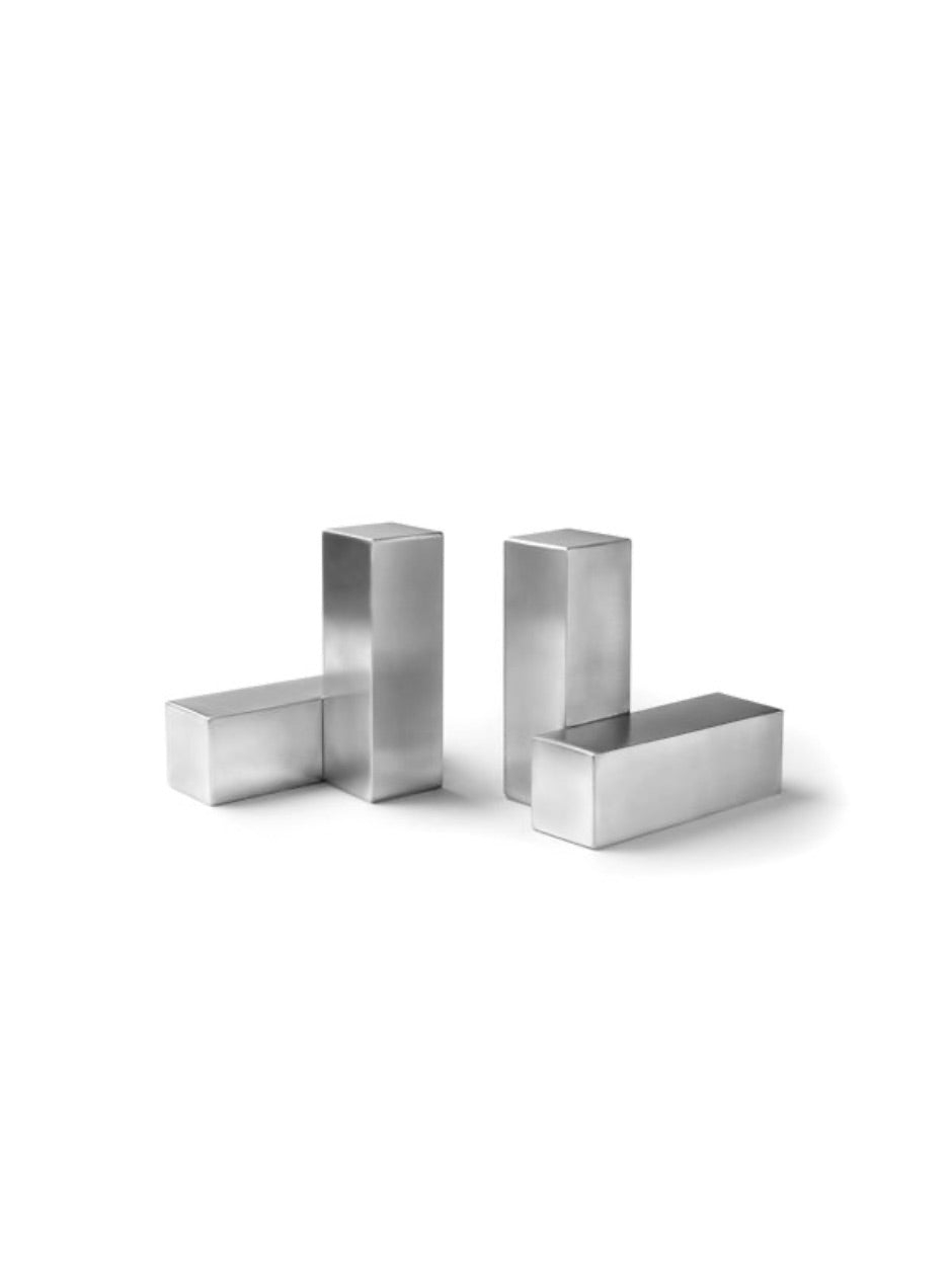 Pair of pewter bookends designed by Nicolas Schuybroek  
Minimalist pewter bookends with sculptural form  
Solid pewter bookends on a modern bookshelf  
Architectural bookends in brushed pewter finish  
Contemporary metal bookends by Belgian designer  
Close-up of Nicolas Schuybroek pewter bookends  
Elegant, heavy-duty bookends in minimalist style  
Designer bookends on a desk with stacked books  
Monolithic pewter bookends styled in a modern interior  
Sculptural pewter objects used as functional bookends