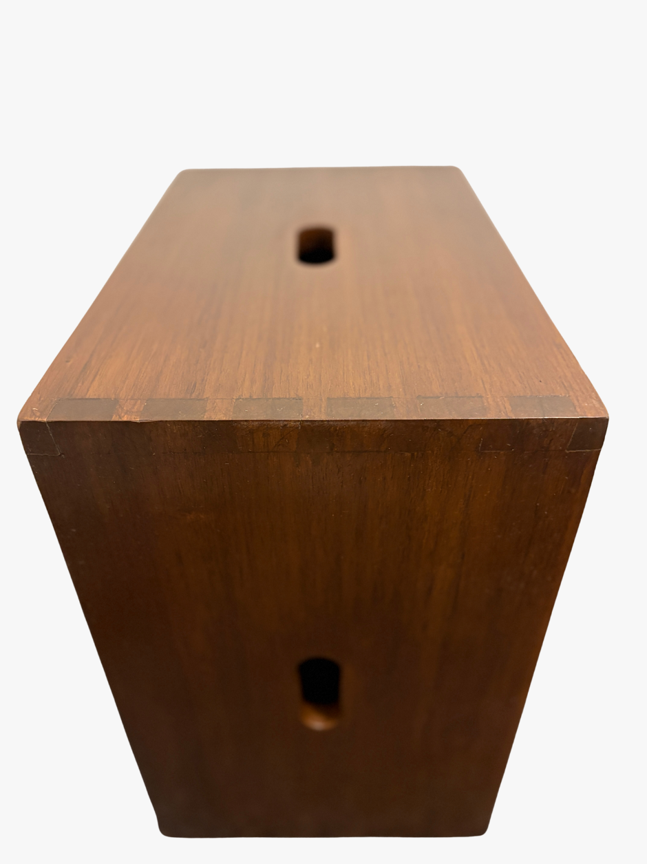 Wooden block with two holes on a white background