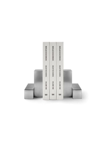 Pair of pewter bookends designed by Nicolas Schuybroek  
Minimalist pewter bookends with sculptural form  
Solid pewter bookends on a modern bookshelf  
Architectural bookends in brushed pewter finish  
Contemporary metal bookends by Belgian designer  
Close-up of Nicolas Schuybroek pewter bookends  
Elegant, heavy-duty bookends in minimalist style  
Designer bookends on a desk with stacked books  
Monolithic pewter bookends styled in a modern interior  
Sculptural pewter objects used as functional bookends